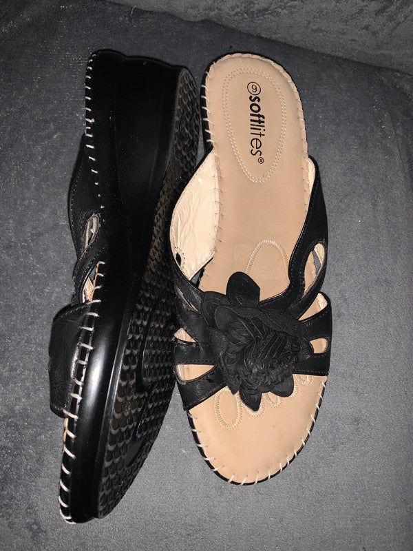 Softlites black wedge sandals with a woven flower detail on the front.