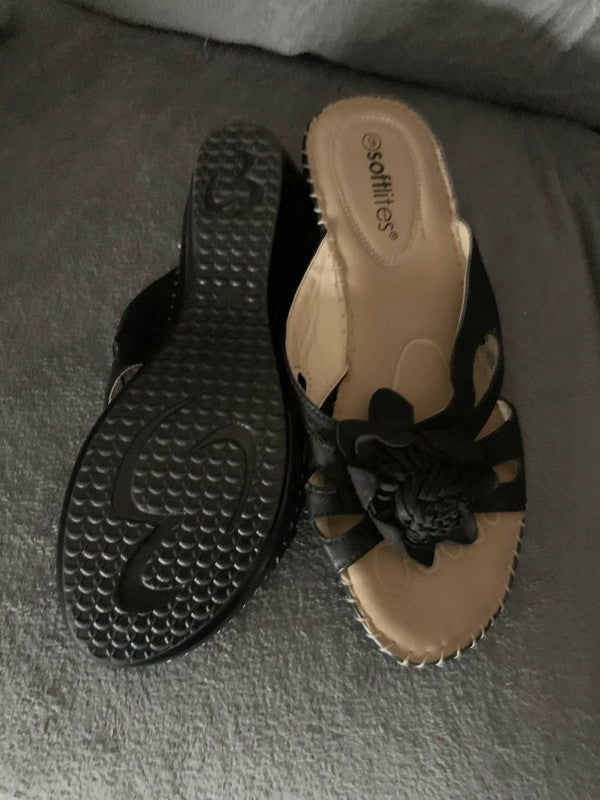 Softlites black wedge sandals with a woven flower detail on the front.