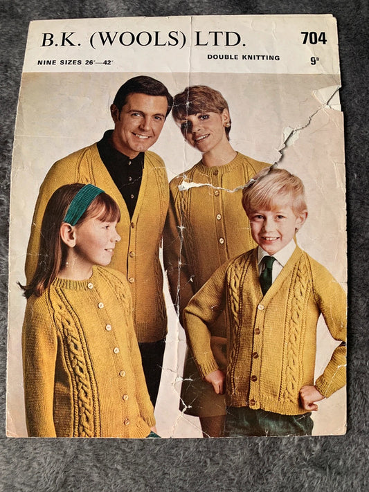 B.K. (Wools) Ltd 704 – Family Cable Cardigans DK 26–42in