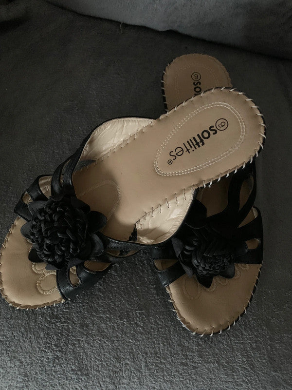 Softlites black wedge sandals with a woven flower detail on the front.
